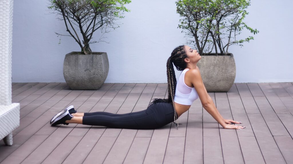 Increased Flexibility - woman in white sports bra and black leggings doing stretching